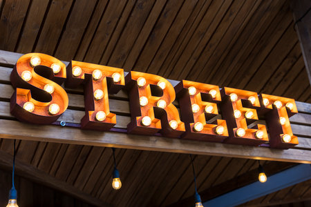 the glowing street sign of the STREET street cafeの写真素材