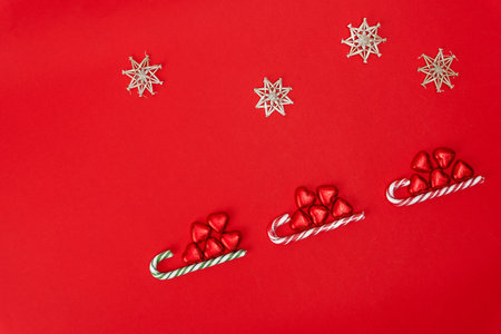 Christmas background with a sled, candy and a caramel cane