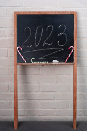 a black slate on which the year 2023 is written in chalk. Happy New Year.の写真素材