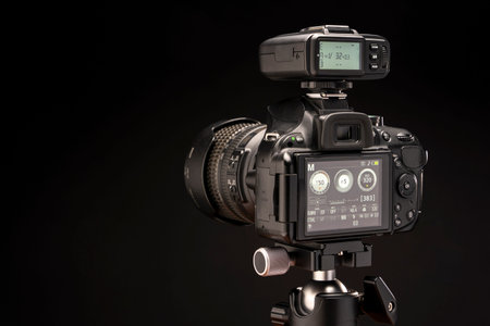 camera is turned on with a flash synchronizer on a black background