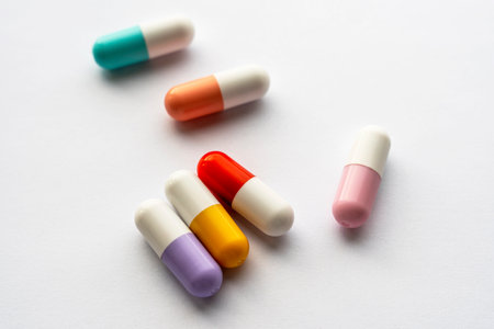 lots of colored pill capsules on a white background. a health problem.の写真素材
