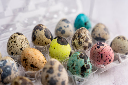 colorful Easter eggs in a container on a light backgroundの写真素材