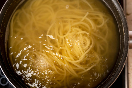 Cooking delicious spaghetti in boiling waterの写真素材