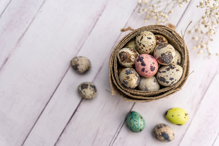 quail eggs in a decorative matting nest on the table
