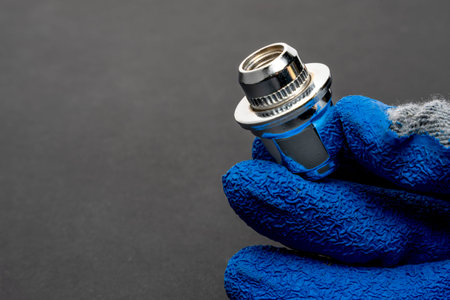 Shiny new wheel nut in the hand of a car mechanic