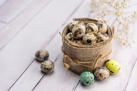 quail eggs in a decorative matting nest on the table