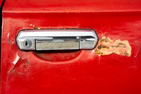 old car door handle close-up. The red door of an old carの写真素材