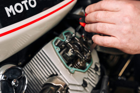 adjusting engine valves of motorcycle at the workshop