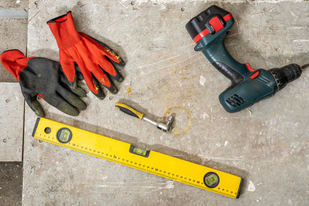 Construction tools on the table. cordless screwdriver, ruler, screws