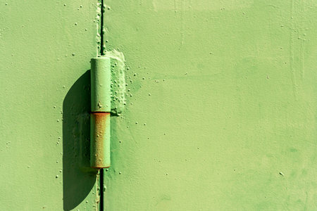 Metal hinge of the garage door. Powerful door hinge.の写真素材