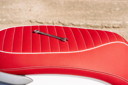 a wrench on the leather seat of a motorcycle during repairの写真素材