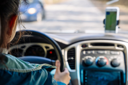 unrecognizable woman or girl drives a car