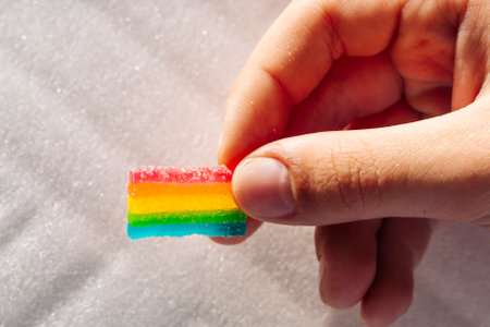 Rainbow marmalades in the childs hand. Goodies and sweetsの写真素材