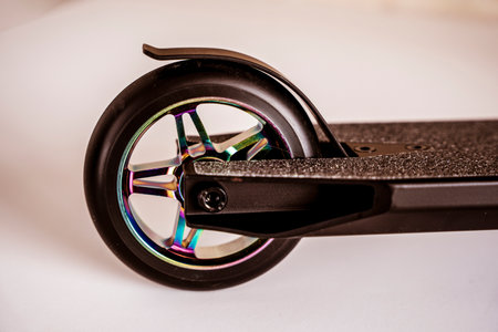 rear wheel and brake of a Stunt scooter with rainbow-colored wheelsの写真素材