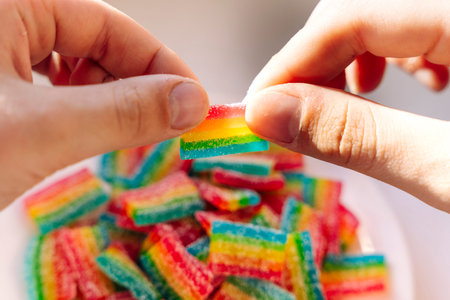 A plate of Rainbow marmalade in the hands of a child in the sunlight