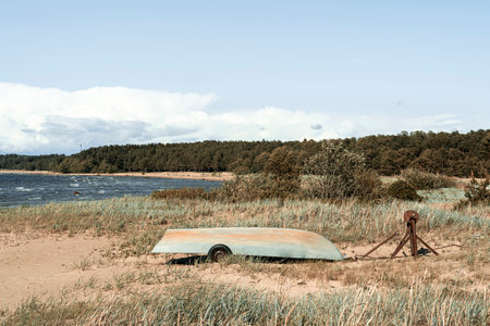 Old fishing boats pulled out on the sandy shore of the sea bayの写真素材