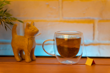 A glass electric kettle on a wooden table and a transparent mugの写真素材