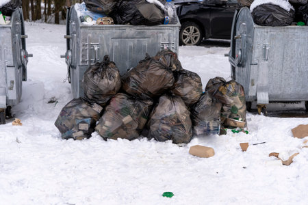 overflowing garbage containers on the site around which garbageの写真素材