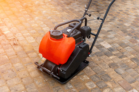 Gasoline Vibrating rammer with a vibrating plate on construction site