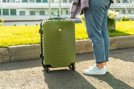 woman while sitting with a suitcase for road tripsの写真素材