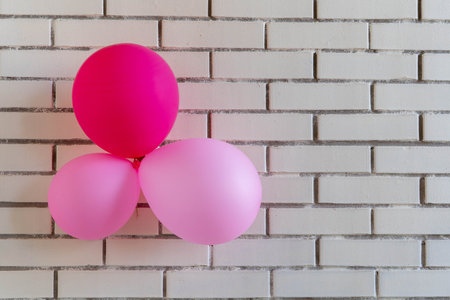 festive red balloons on a brick wall background. Concept holiday birthday.の写真素材