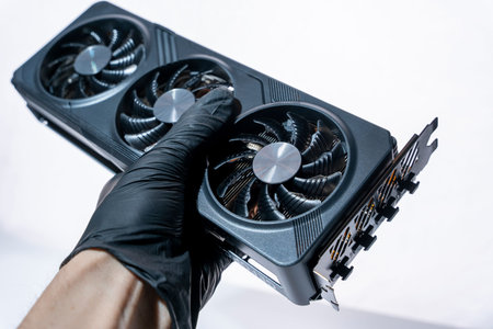 hand of a computer technician holds a modern powerful video game card