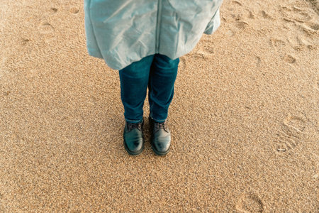 a girl walks on an autumn deserted beach.
