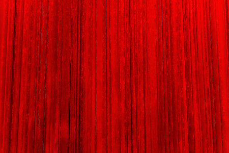 A curtain made of red plush fabric covering the stage. Red color fabric cloth textured, textile backgroundの写真素材