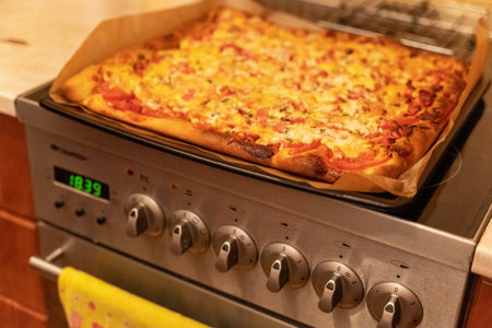 A delicious thin crust pizza topped with a generous amount of gooey melted cheese, savory sausage, and fresh, crisp cucumbers, perfect for tantalizing taste buds.の写真素材
