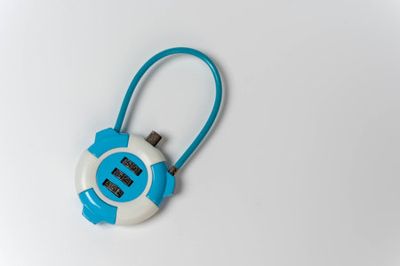 Close-up of combination lock on white background with copy space