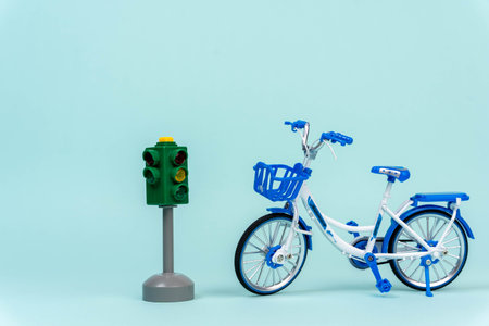 Toy bike and traffic light symbolizing the importance of road safety