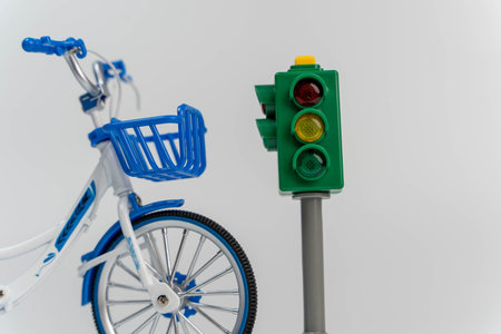 Toy bike and traffic light symbolizing the importance of road safety