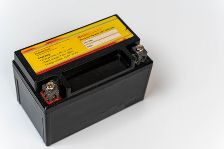 Small battery for moped or motorcycle on white background with copy space