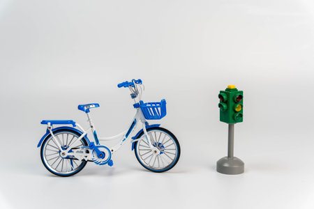 Miniature bike placed next to a working traffic signal.の写真素材