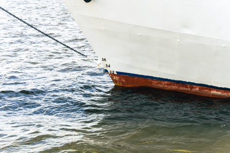 A boat is securely docked in the water with a rope tied to itの写真素材