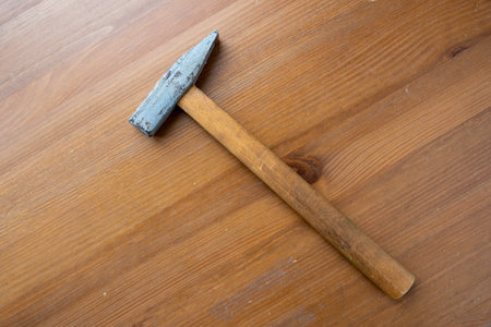 Hammer Laying on Wooden Floorの写真素材