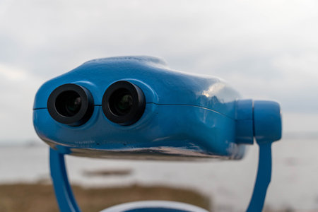 Metal stationary outdoor binoculars on the observation deck overlooking the sea.の写真素材