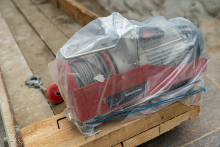 Electric winch is securely wrapped and awaiting installation at the siteの写真素材