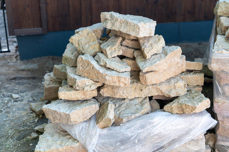 Natural stones are neatly piled in an outdoor setting