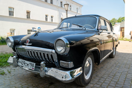 Russia, Valaam Island, July 27, 2024 - GAZ 21, Volga, classic automobile parked along a picturesque cobblestone roadのeditorial素材