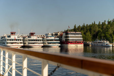 Russia, St. Petersburg, July 27, 2024 - Several boats are tied up at the harbor under bright sunlightのeditorial素材