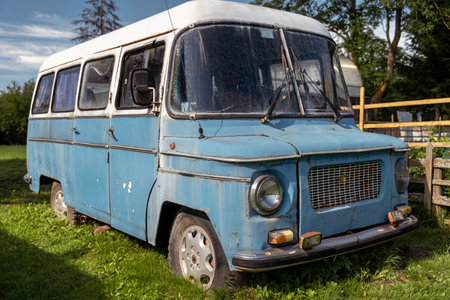 Pskov Region, Russia , July 21, 2024 - NYSA, classic blue van rests peacefully in a grassy areaのeditorial素材