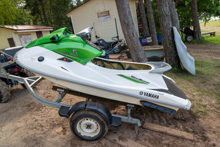 Pskov Region, Russia , July 16, 2024 - green jet ski Yamaha is parked on a trailer by the lakeのeditorial素材