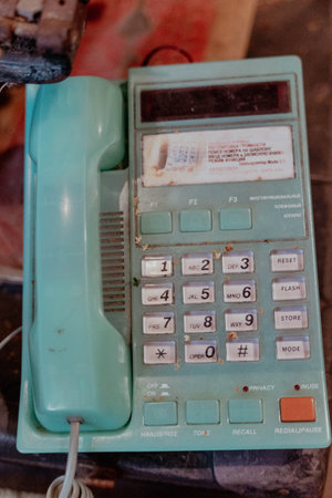 Pskov Region, Russia , July 21, 2024 - dusty turquoise telephone rests on a wooden tableのeditorial素材