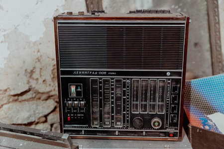 Pskov Region, Russia , July 21, 2024 - vintage radio Leningead 006 sits on a surface in a worn environmentのeditorial素材