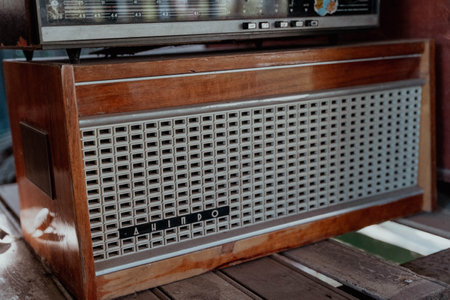 Pskov Region, Russia , July 21, 2024 - classic wooden radio occupies a spot on the rustic table, Dniproのeditorial素材