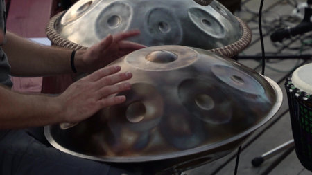 A musician captures rhythms on a handpan in a vibrant setting. Relaxing Music instrumentalの写真素材