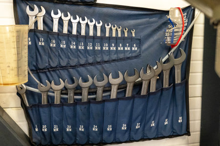 A collection of wrenches arranged by size in a tool holder at a work site.の写真素材