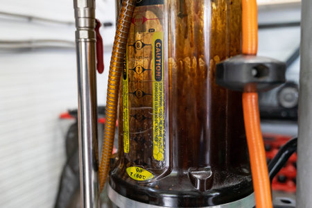 a container for vacuum pumping of used engine oil from a car engineの写真素材