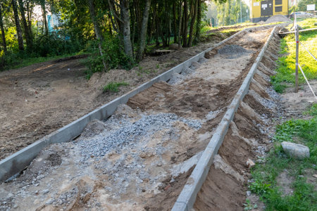 Workers are building a pathway with gravel and concrete in the forest.の写真素材